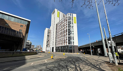 View of the CODE Coventry block from ground level with blue skies.