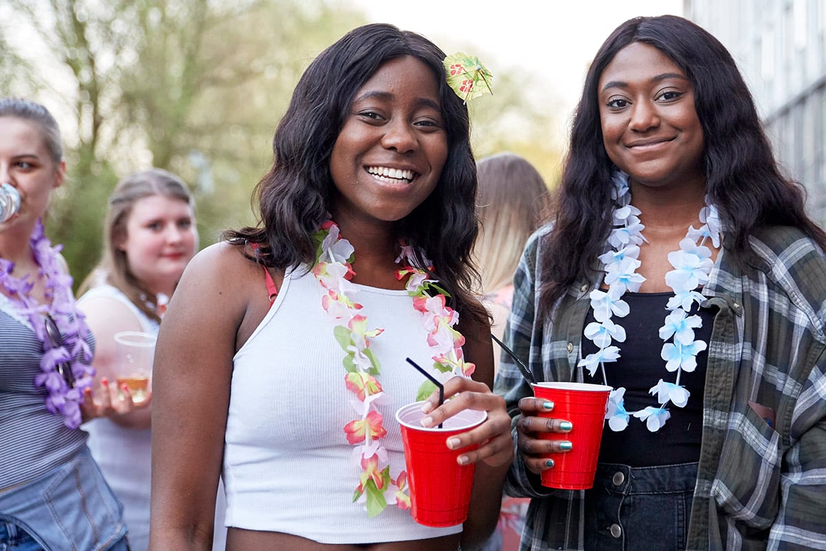 Students with drinks in outdoor space at CODE Student Accommodation Coventry