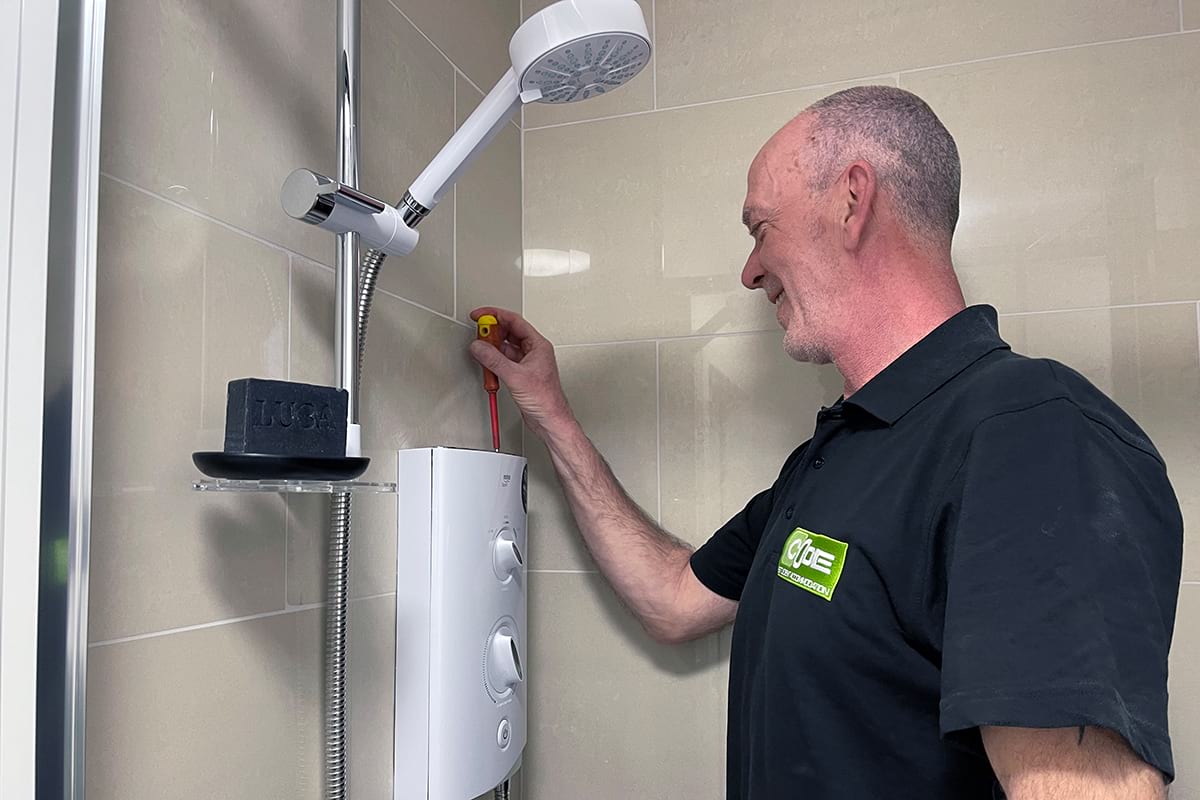Maintenance team member fixing shower in studio flat at CODE Student Accommodation Coventry