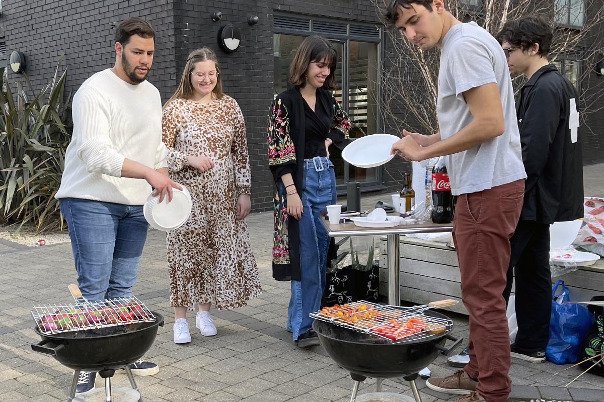 Students having a barbecue outside CODE Student Accommodation Leicester