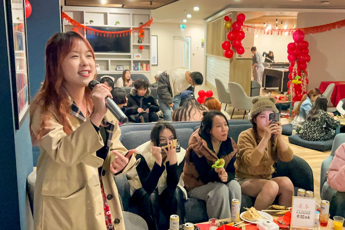 Girl singing with her friends at Lunar New Year event