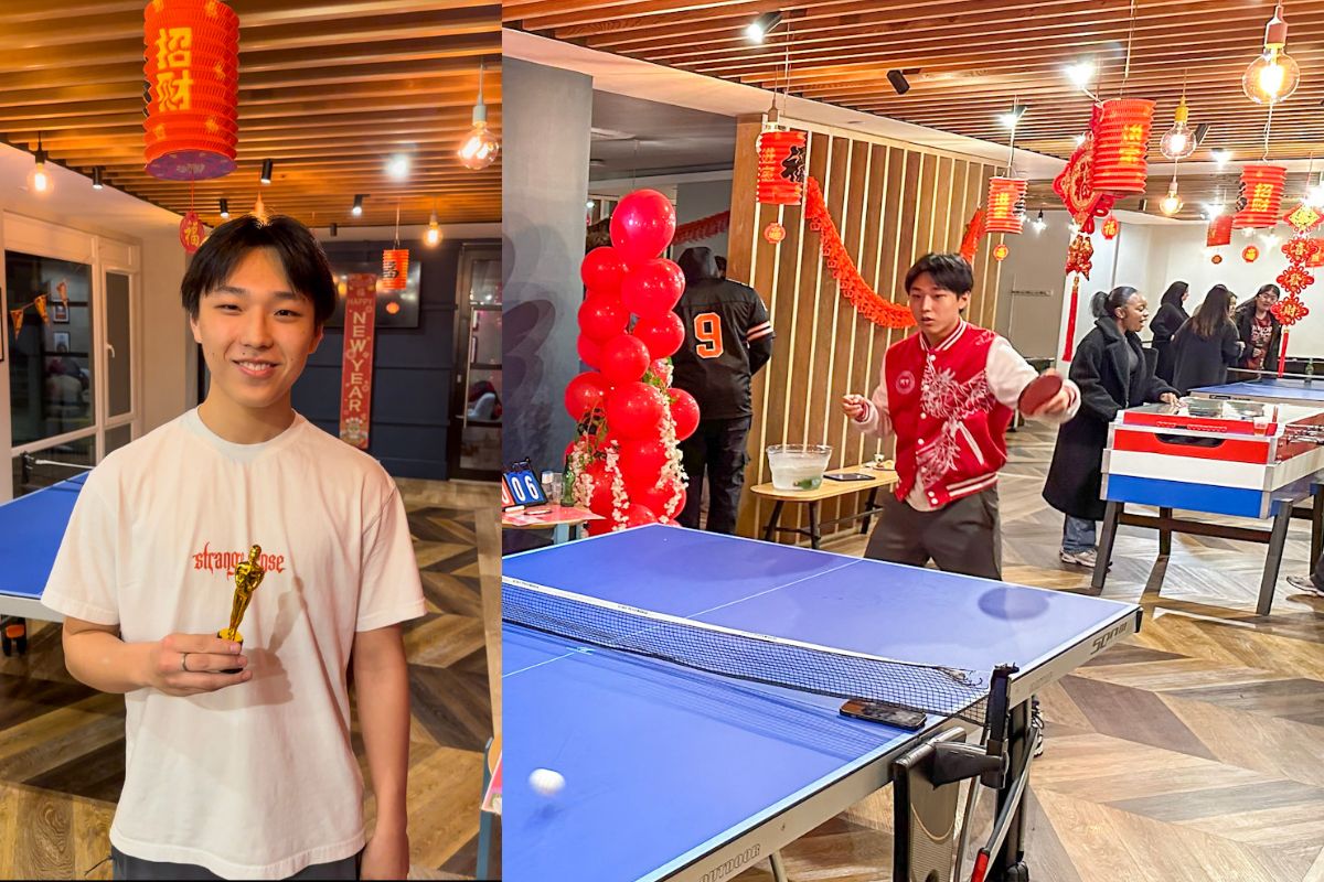 Man winning trophy for table tennis tournament
