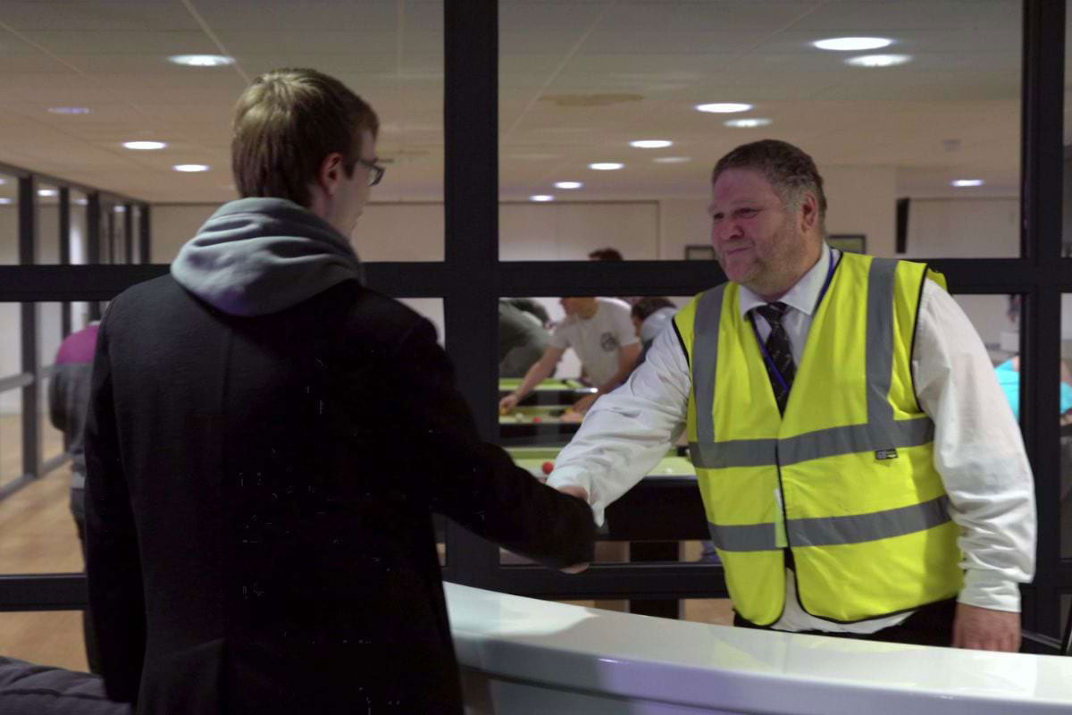 Security guard greeting student at CODE Student Accommodation