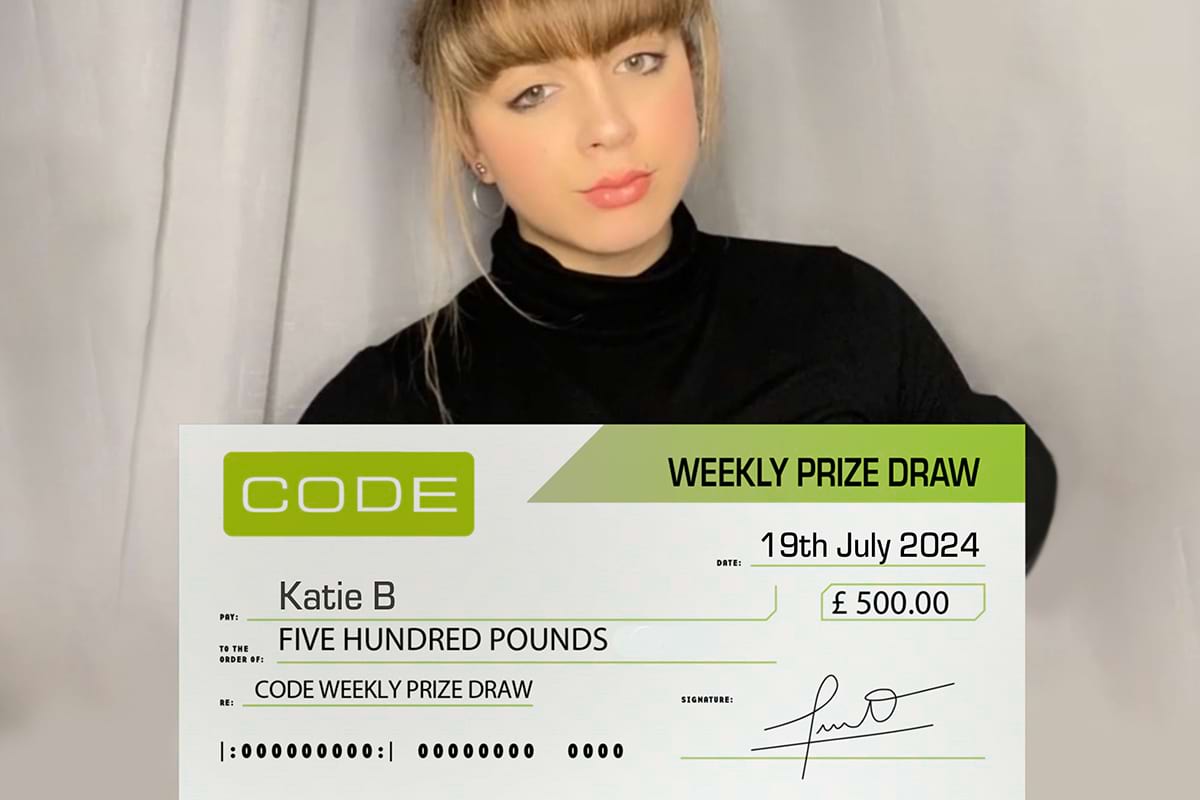 Katie B - week 5 winner - holding £500 cheque