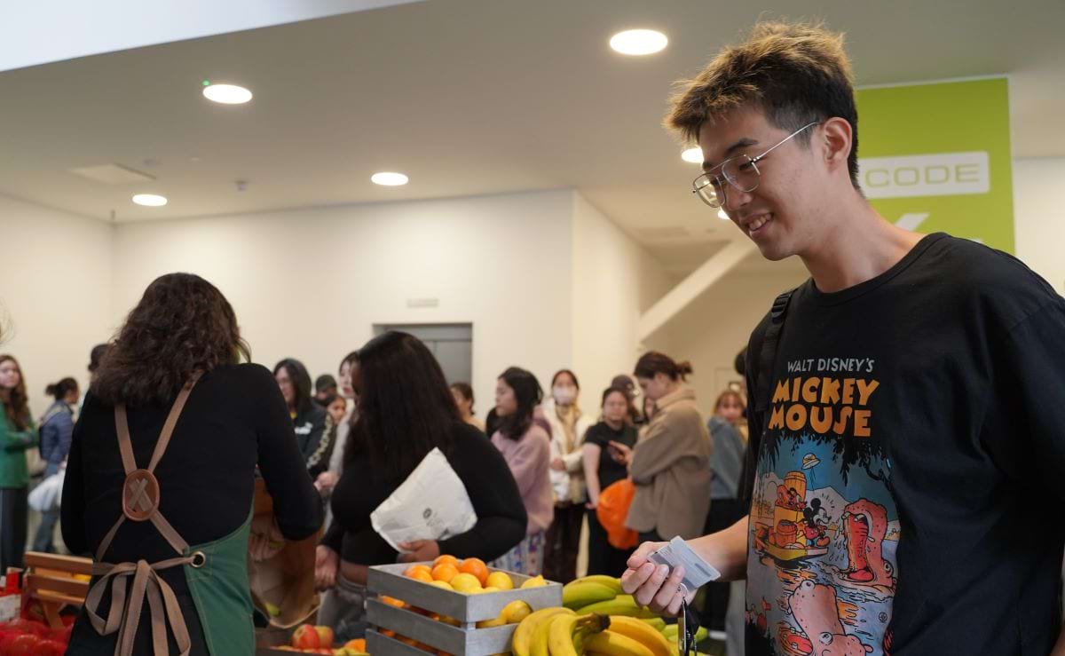 Student browsing the fruit and vegetable stall