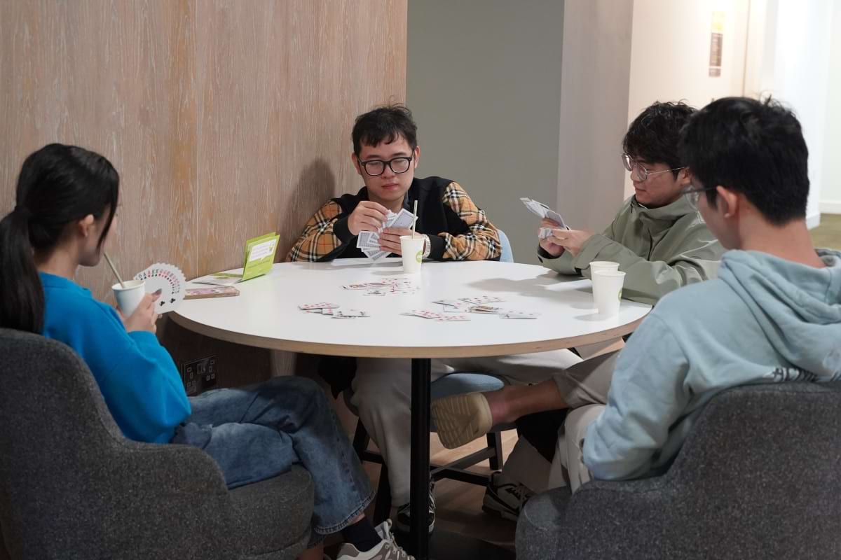 Four friends playing cards and drinking delicious drinks resized