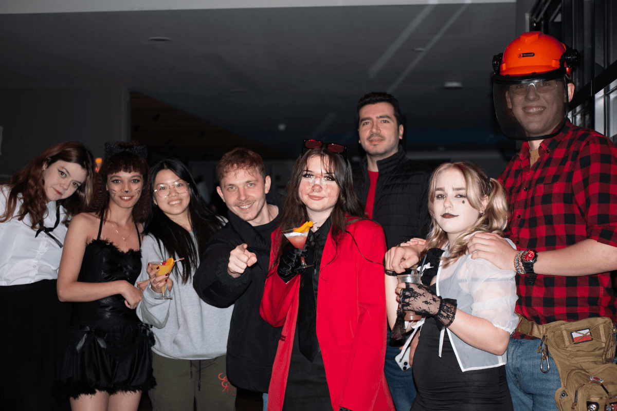 A group of friends pose at the Halloween party with cat costumes and fake blood makeup