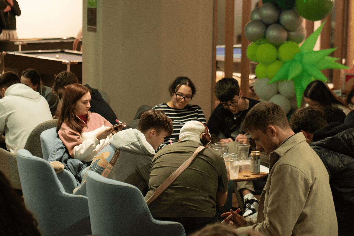 A group of students focusing hard to check their bingo cards