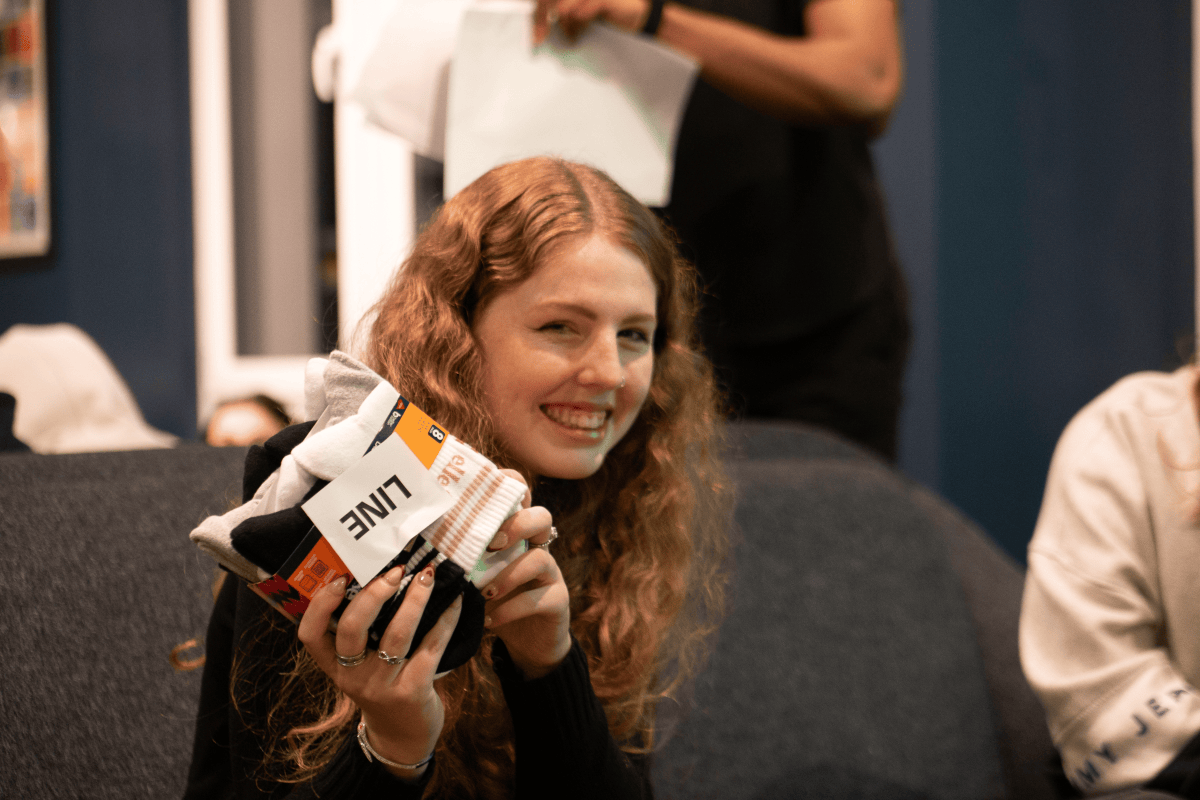 Girl holding up a bingo prize of smart socks