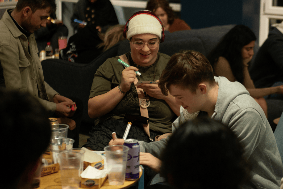 Student marking a Bingo card at the Bingo Event 2024