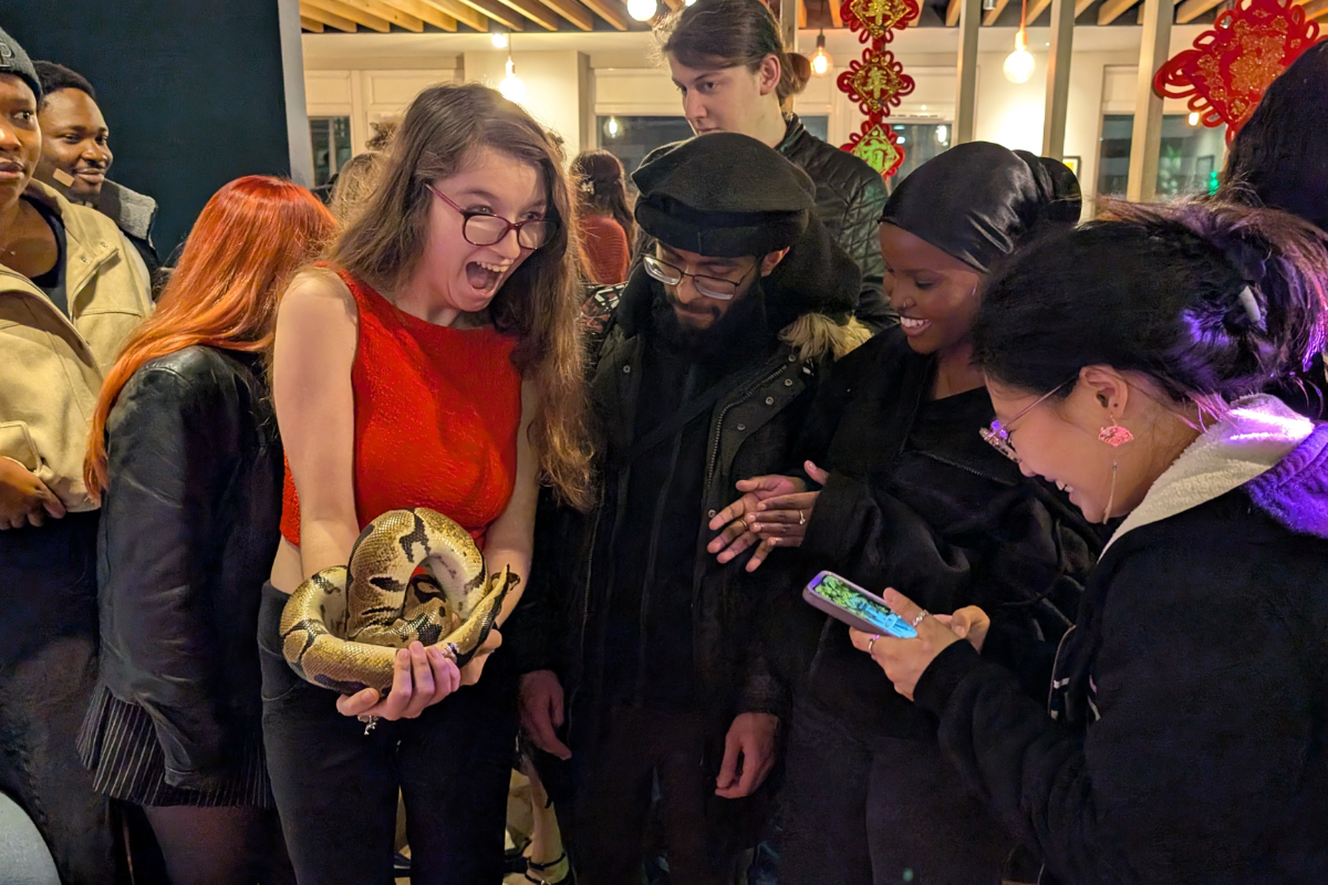 Student is terrified holding a Snake for the lunar year party