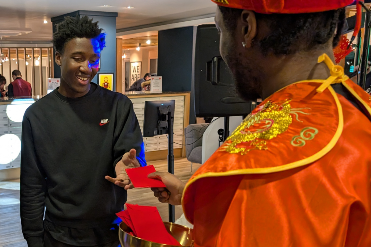 Student receives an envelope for the New Lunar Year