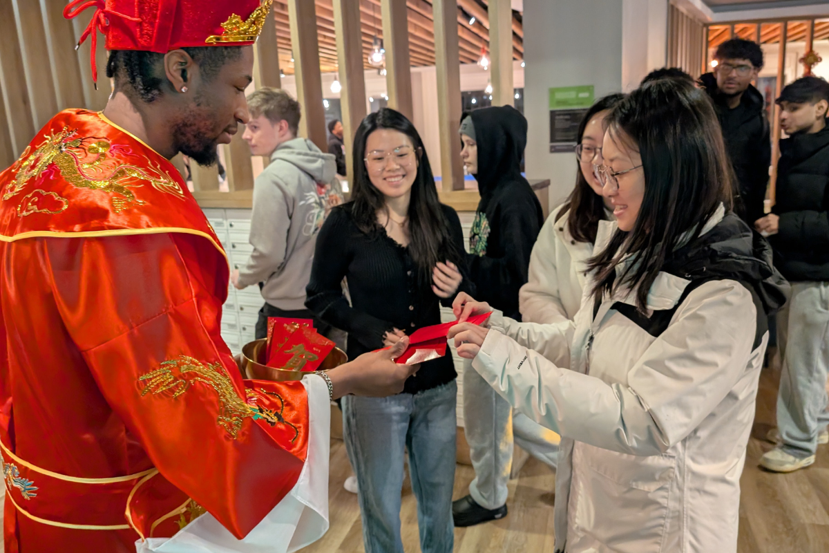 Student accepts offering for the New Lunar Year