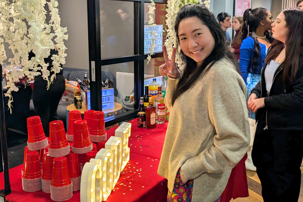 Student throws up a peace sign at The Lunar Party