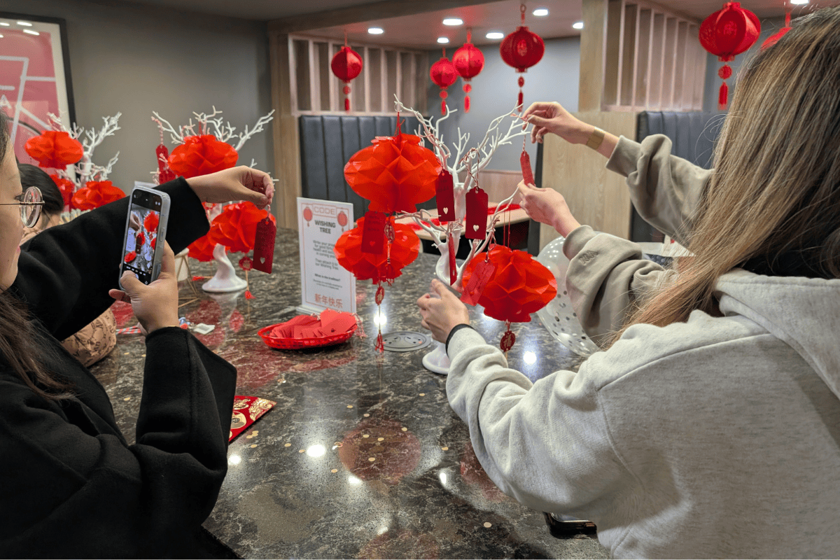 Students take photos of their wish notes together