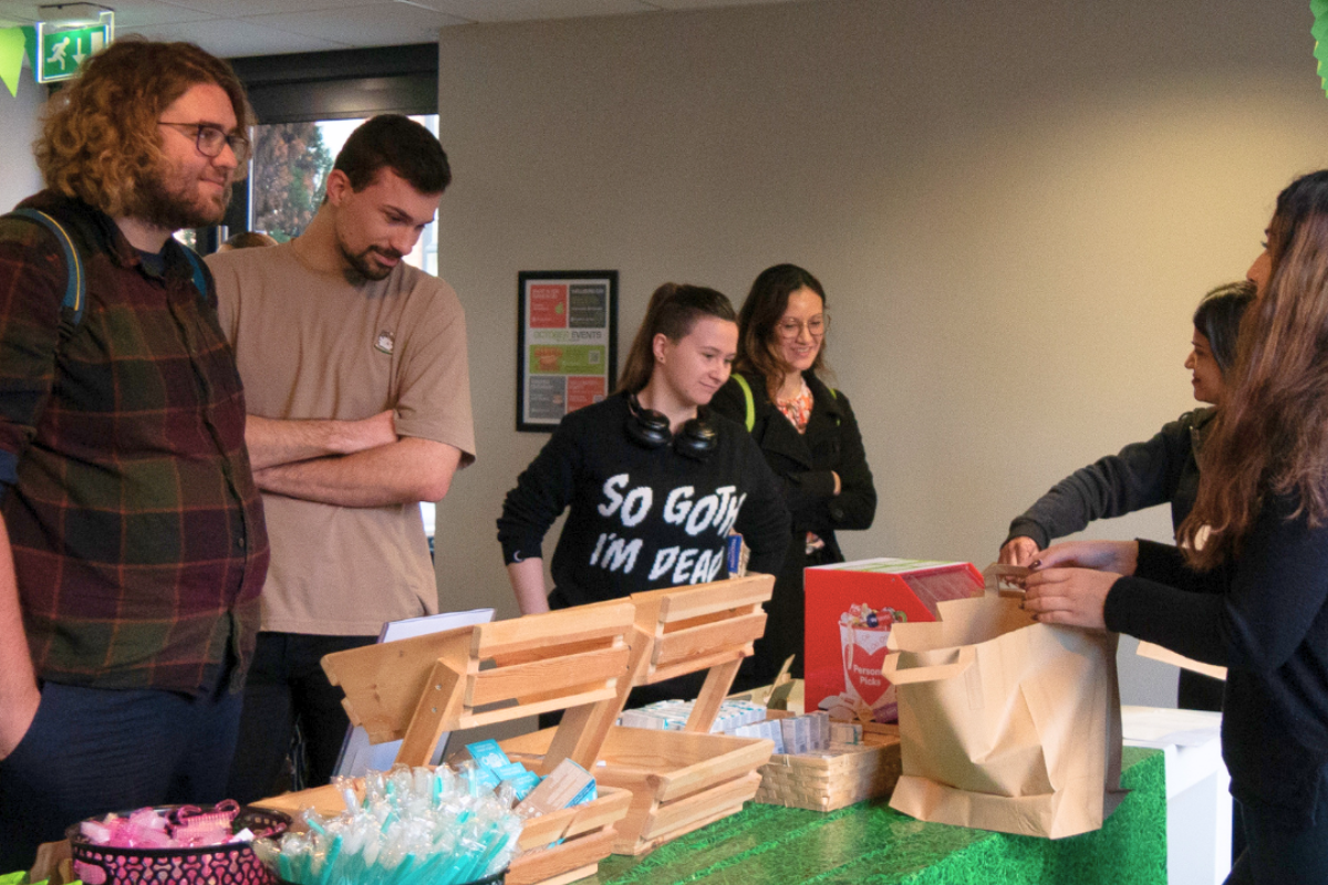 Students looking at our stall full of freebies at our pamper event