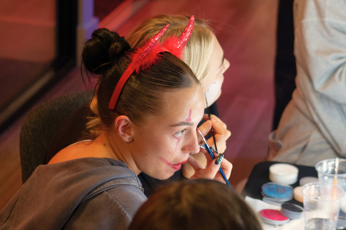 Two girls doing their makeup for the CODE Halloween party 2024