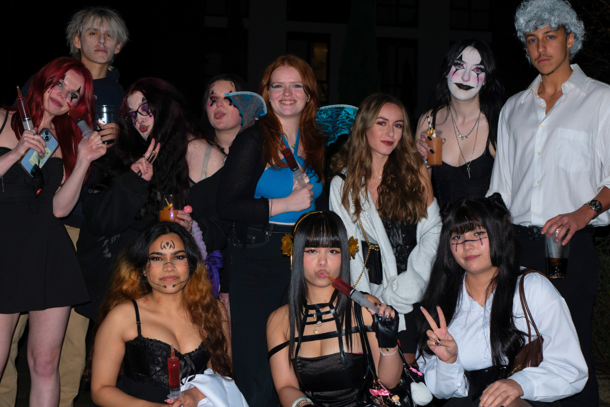 A group of friends in their Halloween costumes posing for the camera