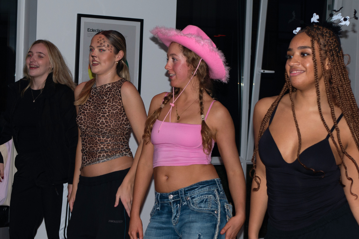 Four girls dancing together at the CODE Halloween party