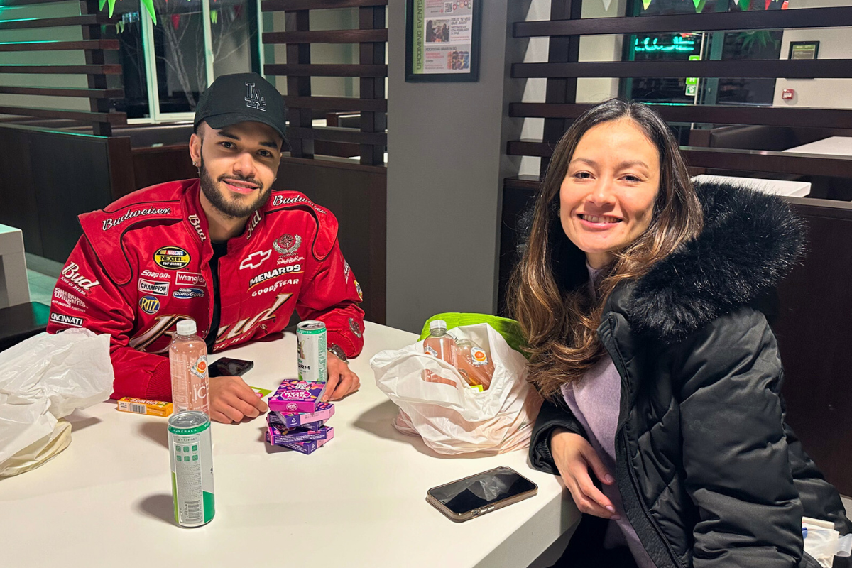 Two CODE tenants sitting down at a table with drinks and sweets