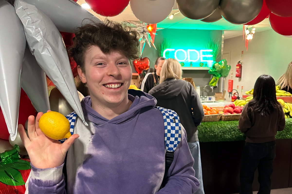 A CODE tenant posing with a lemon