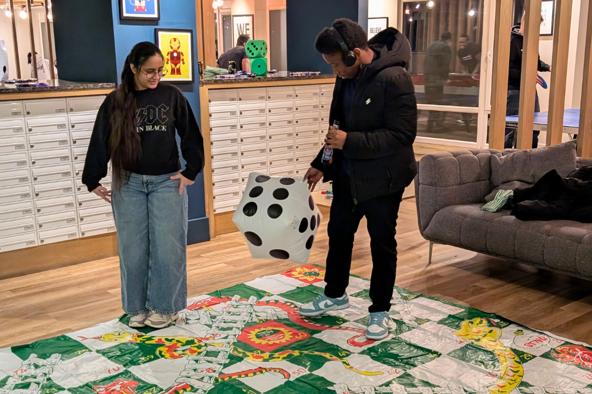 Two students playing snake at the CODE games night