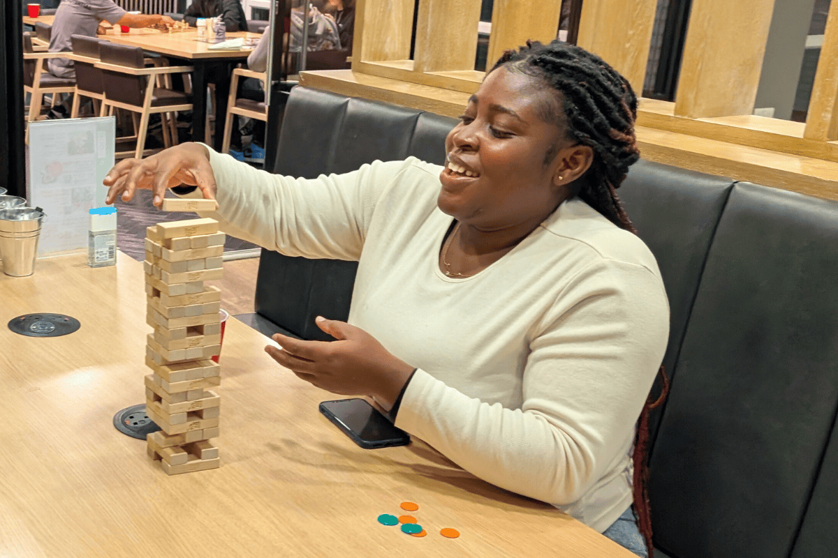 A girl playing Jenga at the CODE event