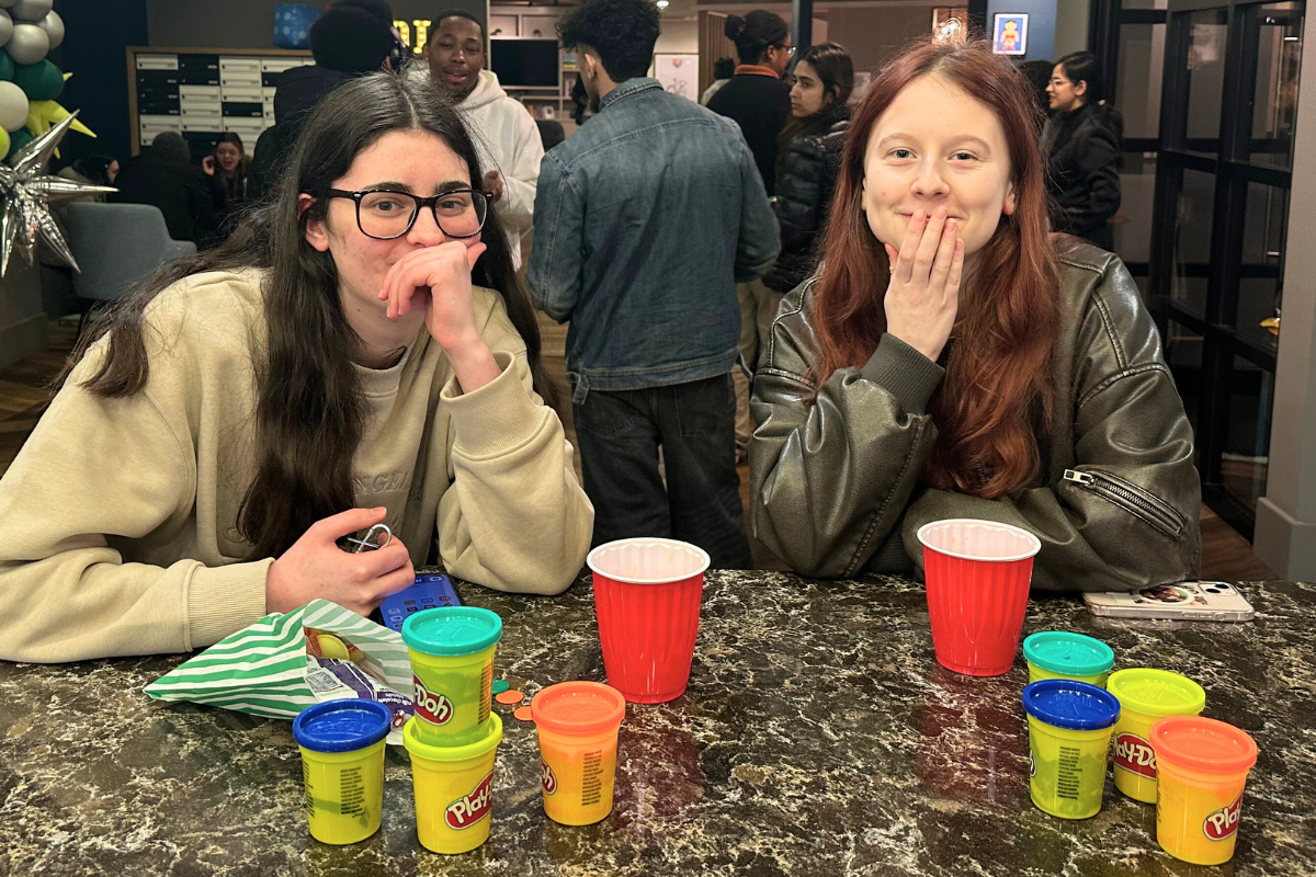 Two tenants sitting by a table with some play-doh in front of them