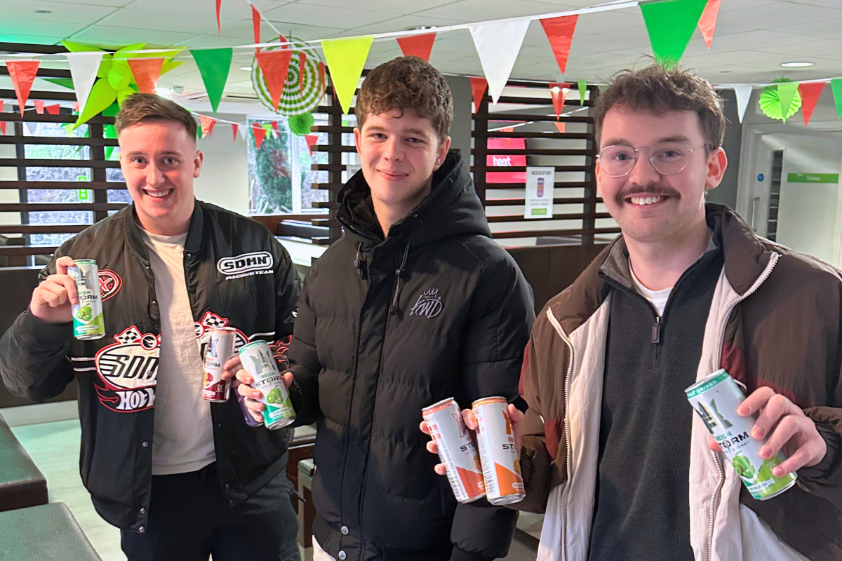 Three CODE tenants holding up their energy drinks at our energy drink giveaway