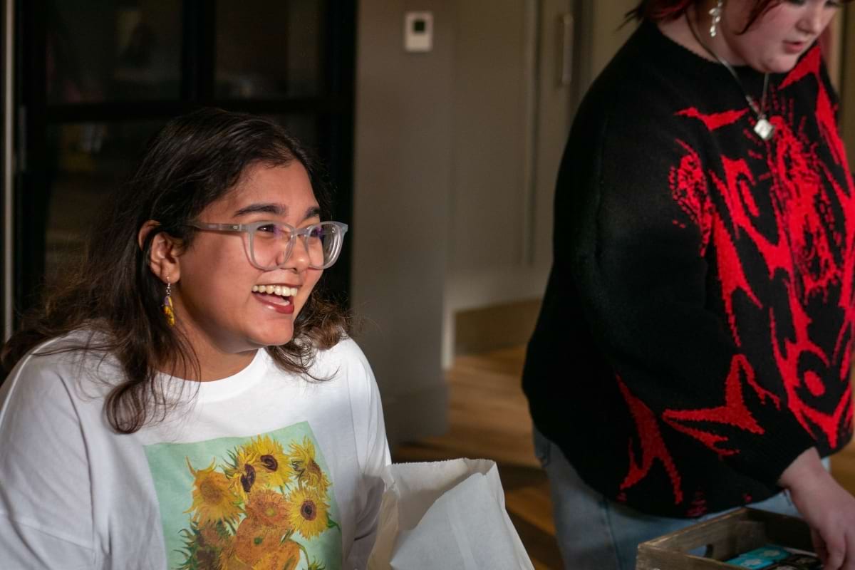 Student smiling in a Van Gogh sunflower T-Shirt