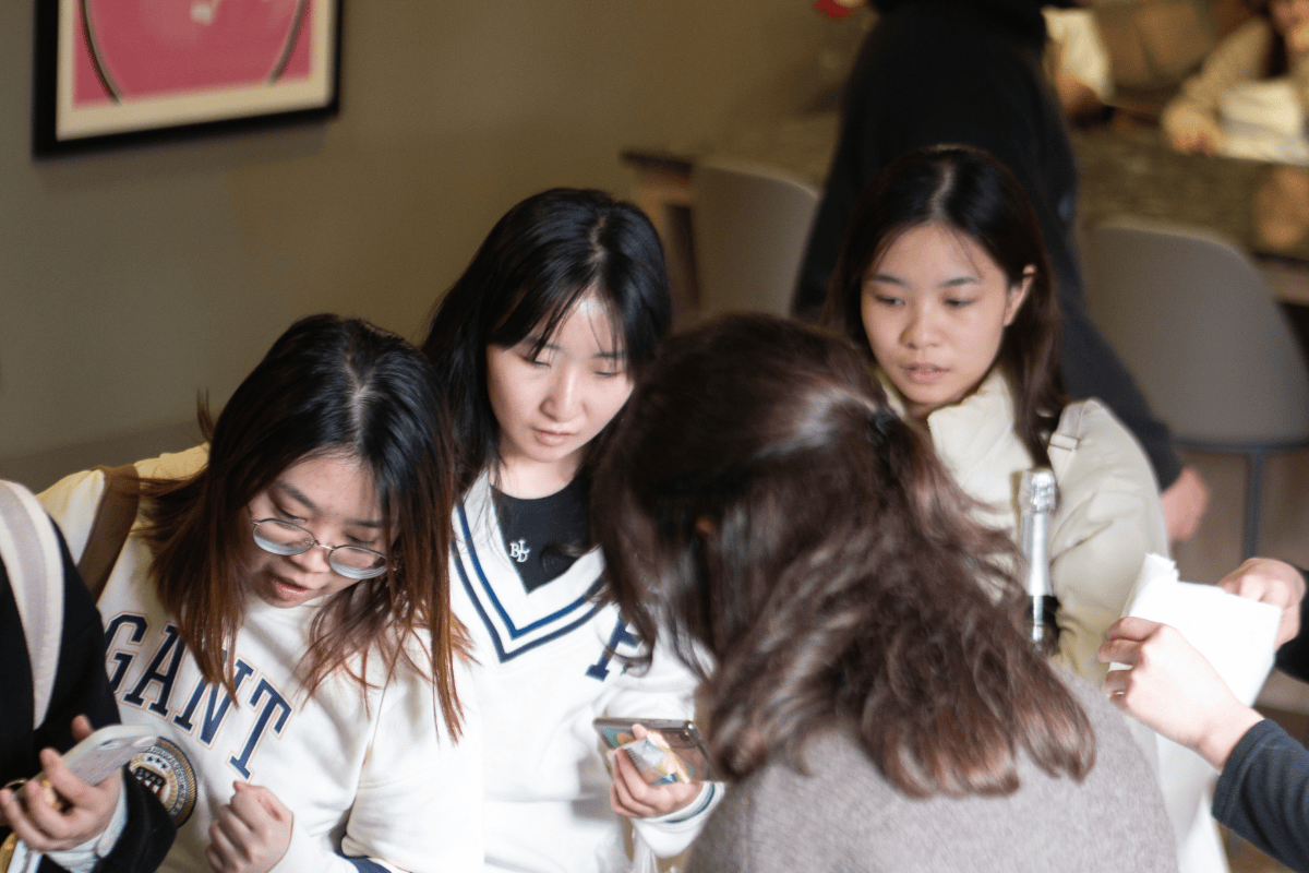 Three students look curious at which pamper products to take