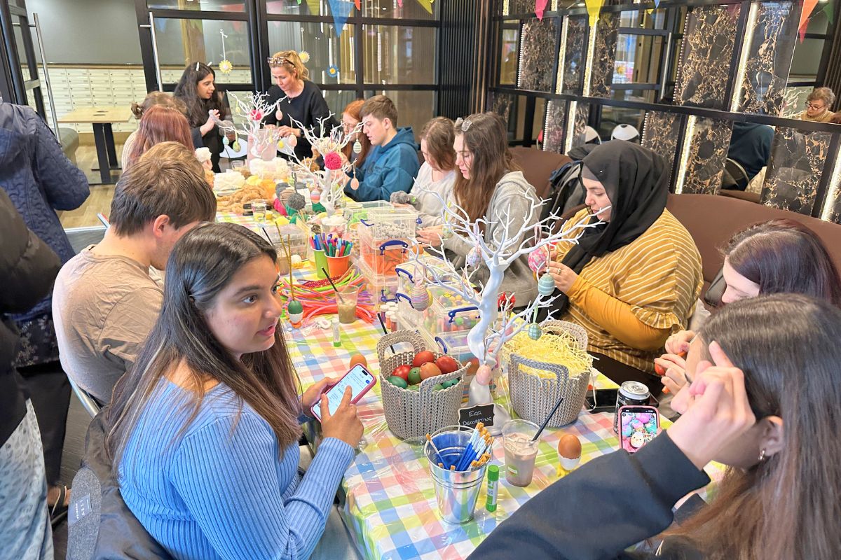 A table with students around it making arts and crafts at the code easter event