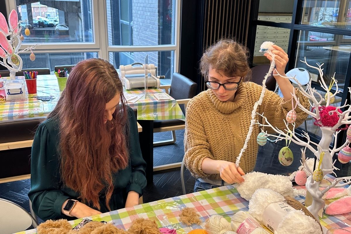 Students making pom-poms at the code easter crafting event