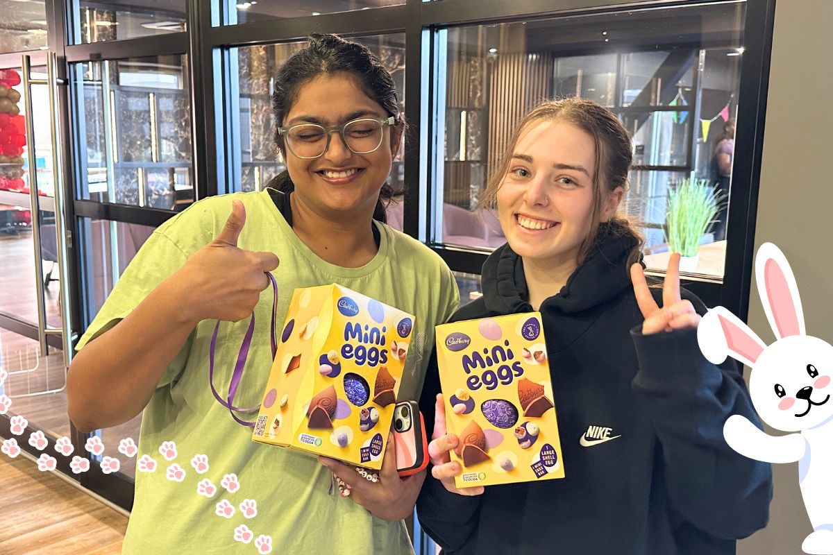 Two girls holding their eggs from the easter egg hunt