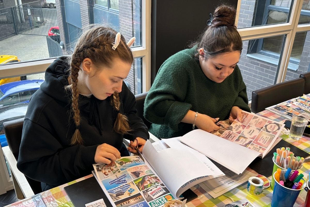 two friends making vision boards together at one of our Code events