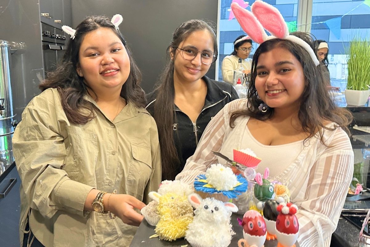 Three girls with a tray full of easter crafts