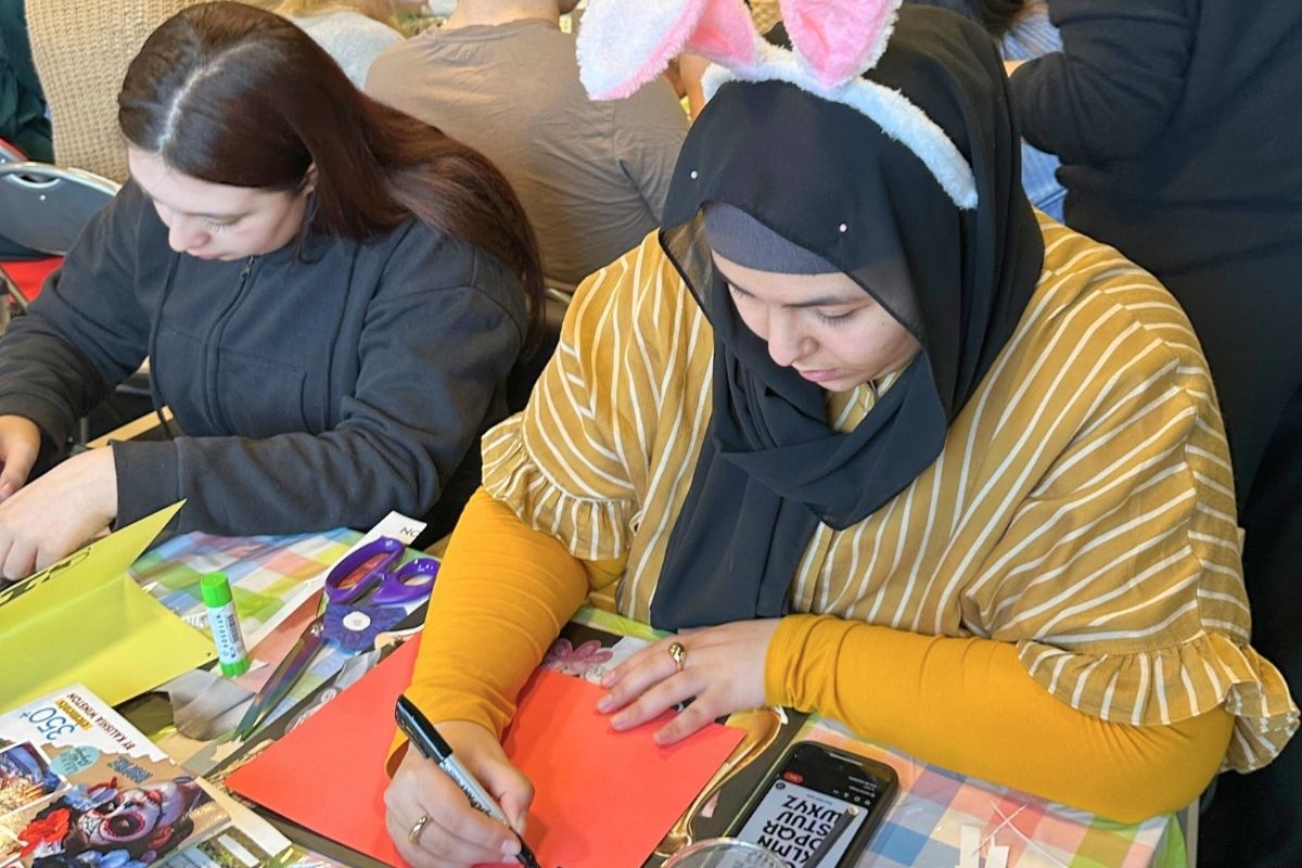 Two code tenants creating vision boards at the easter craft events