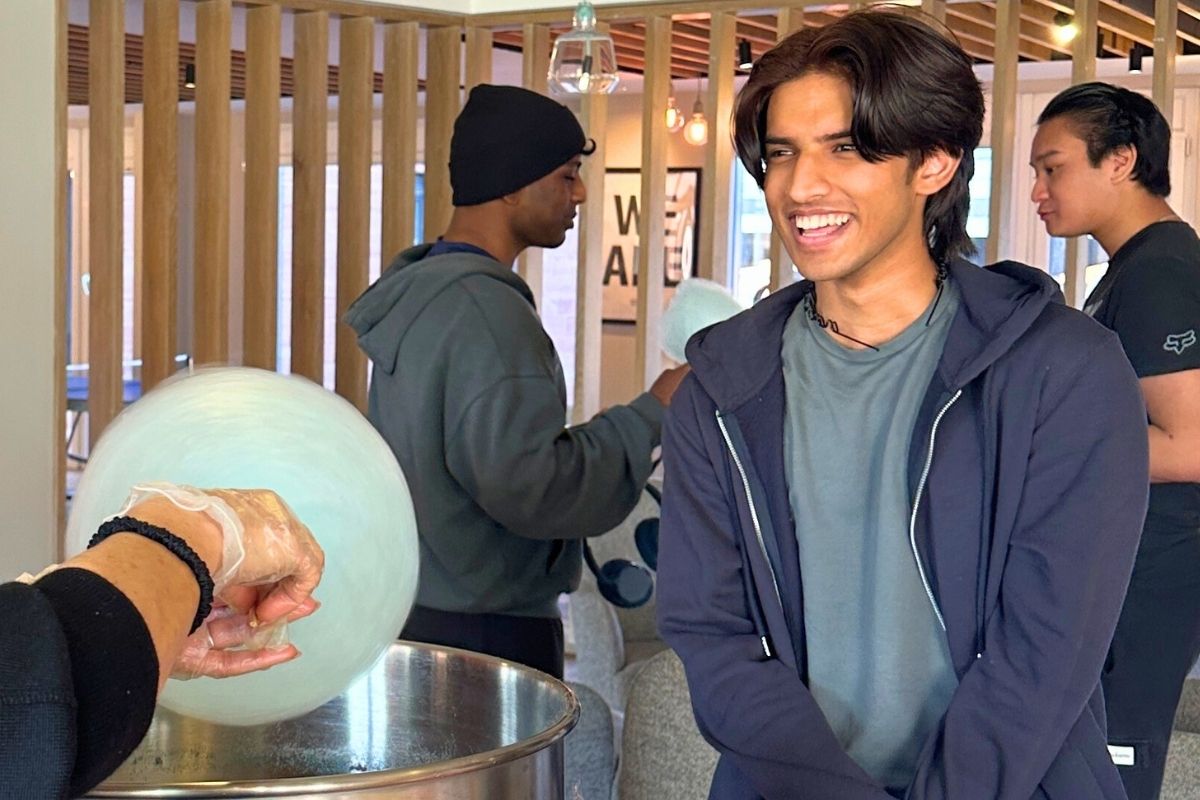 A guy waiting for his candy floss to be made
