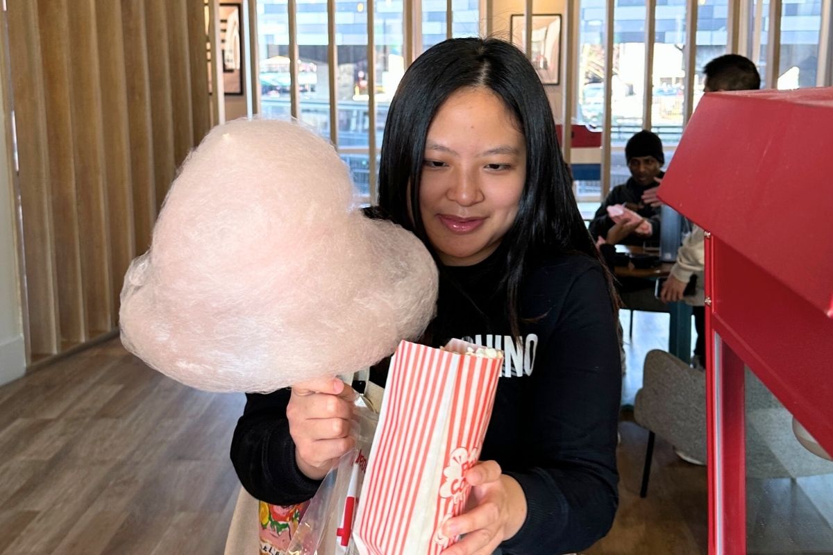A CODE tenant being handed her popcorn and candy floss at the event
