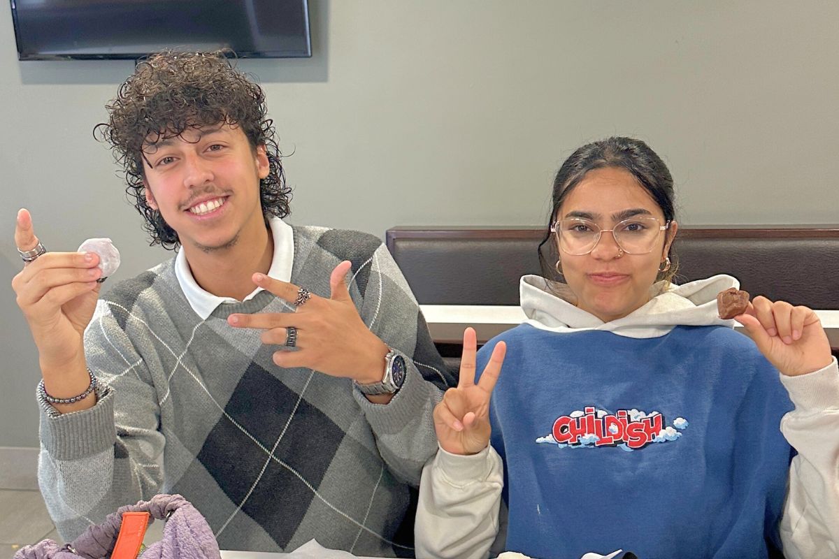 Two students holding up their little moons