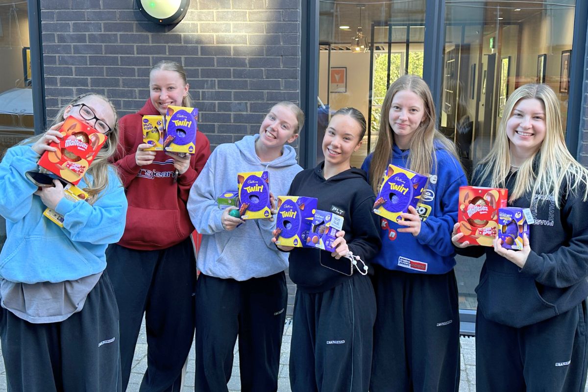 A group of girls holding up their easter eggs that they found during the CODE 2025 Easter egg hunt