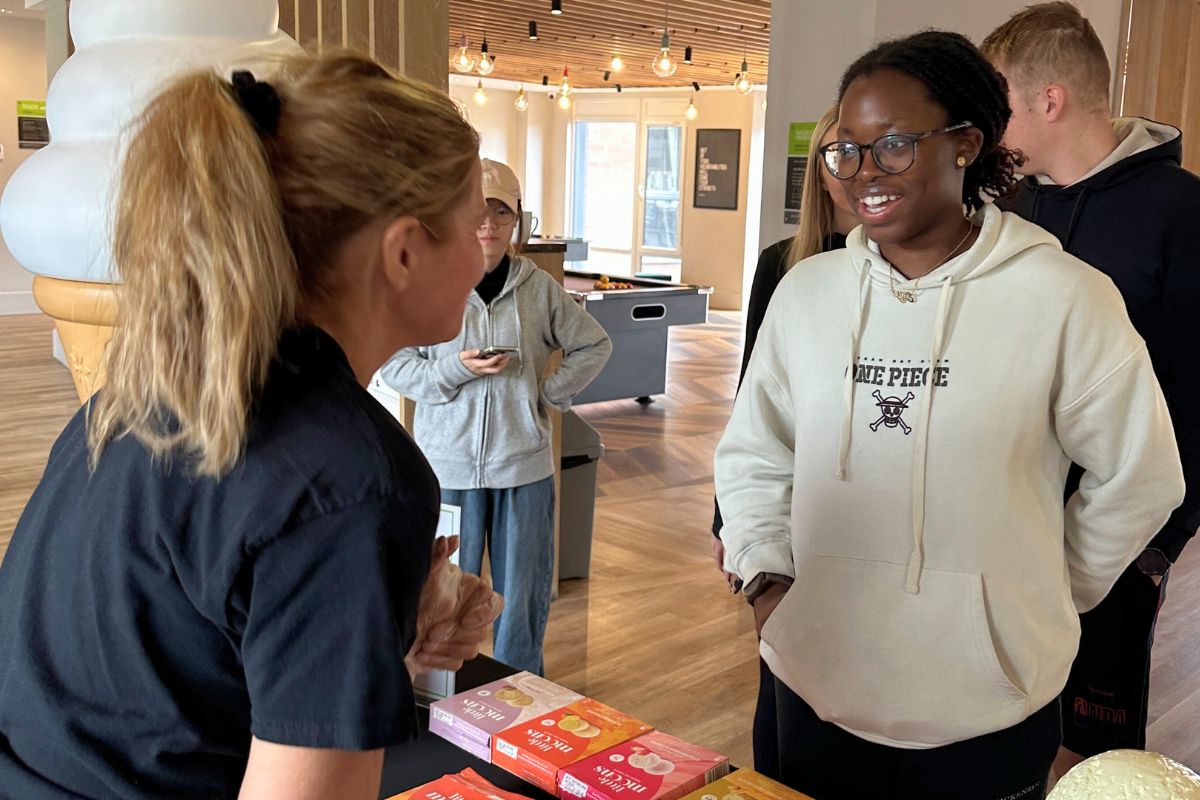 A code team member serving a student little moons at the event