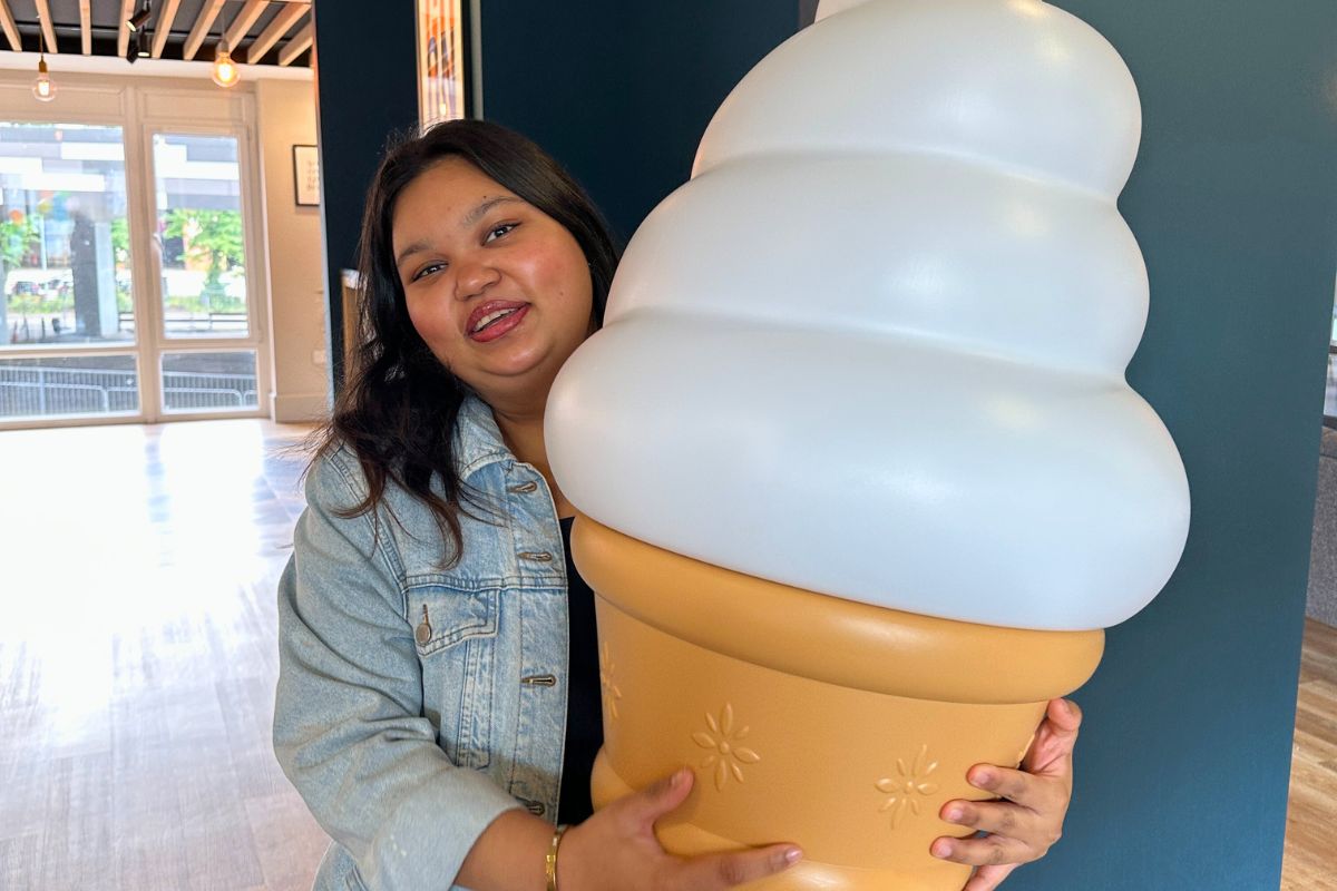 A CODE tenant holding a super sized ice cream prop