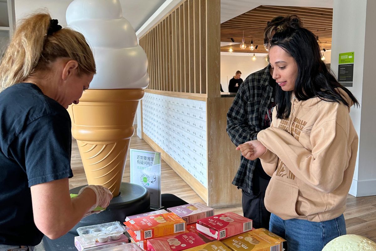 A code team member serving a student little moons at the event