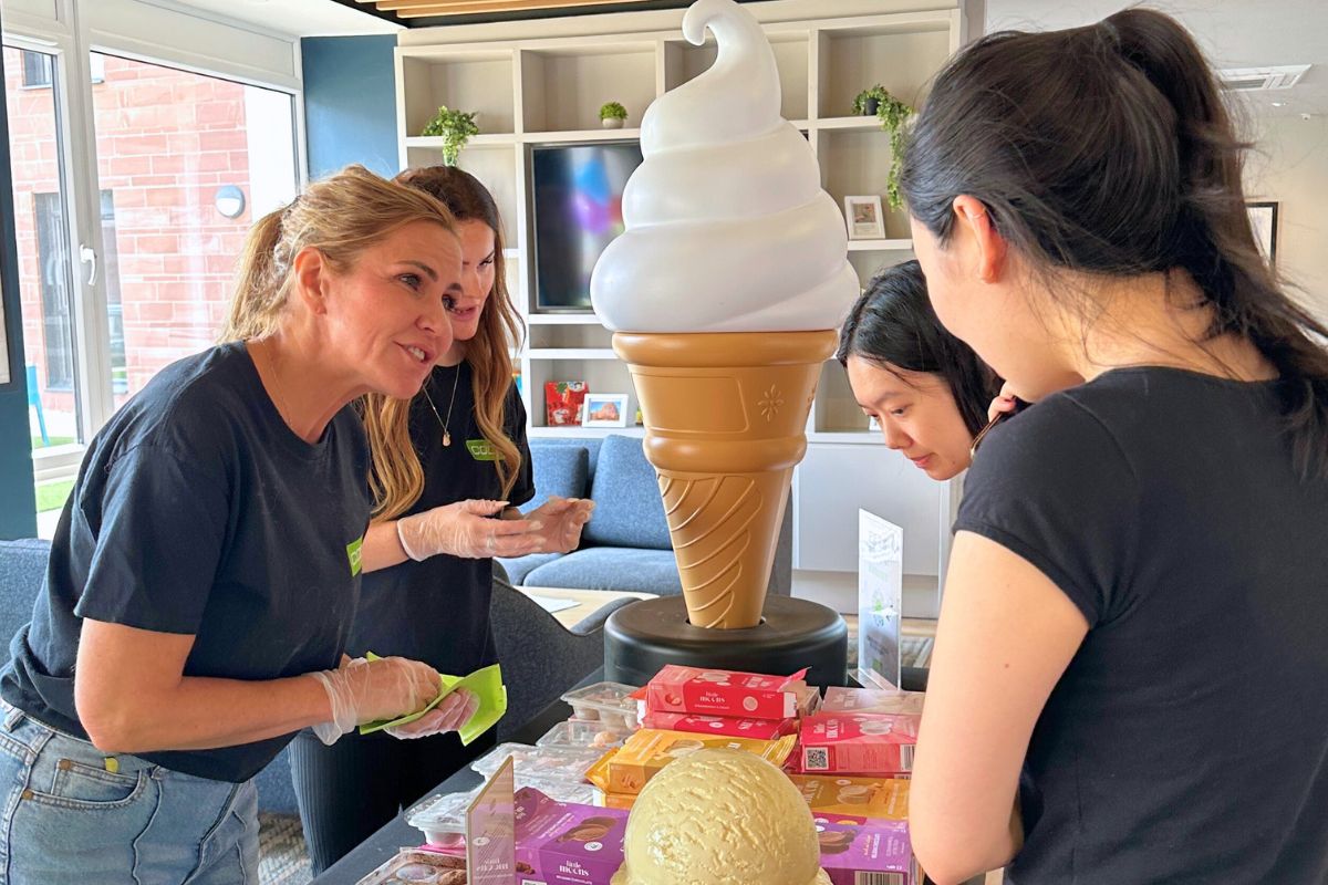 Two students trying to pick what flavour they would like to have at the Little Moons Moochie event