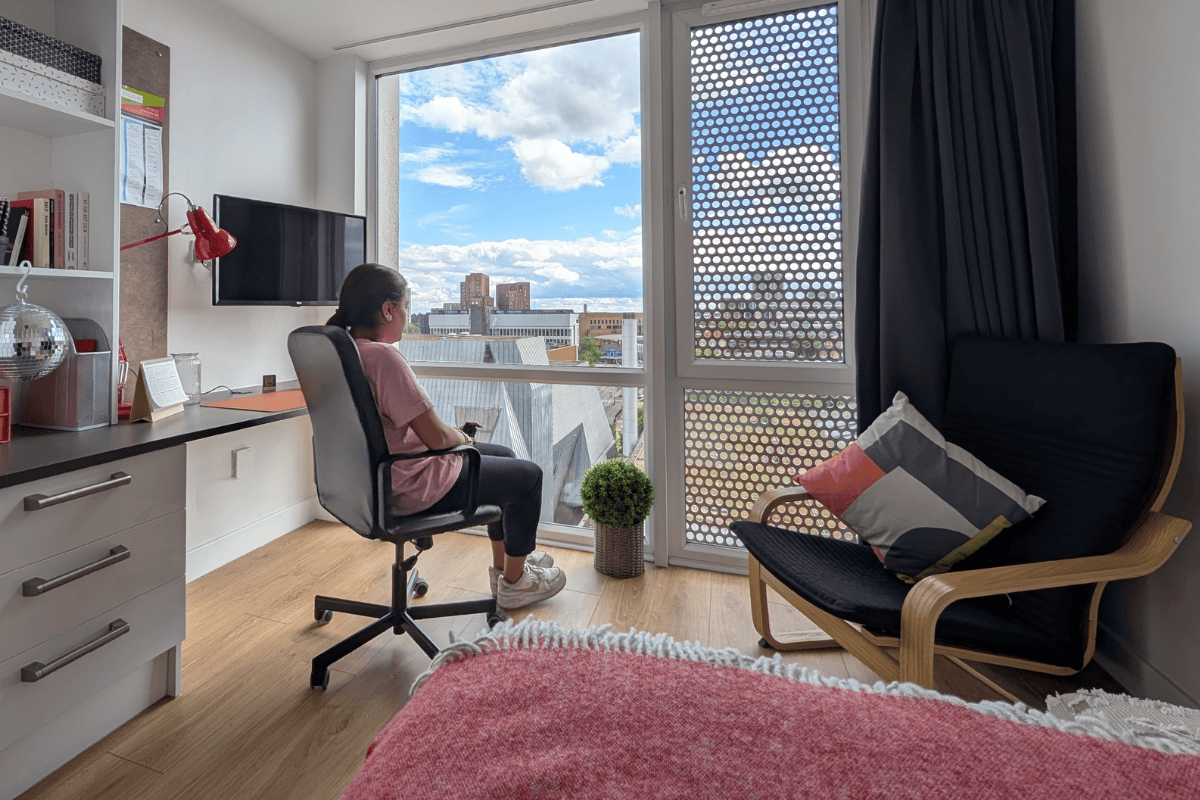 Student looking out of studio window at CODE Fairfax Street