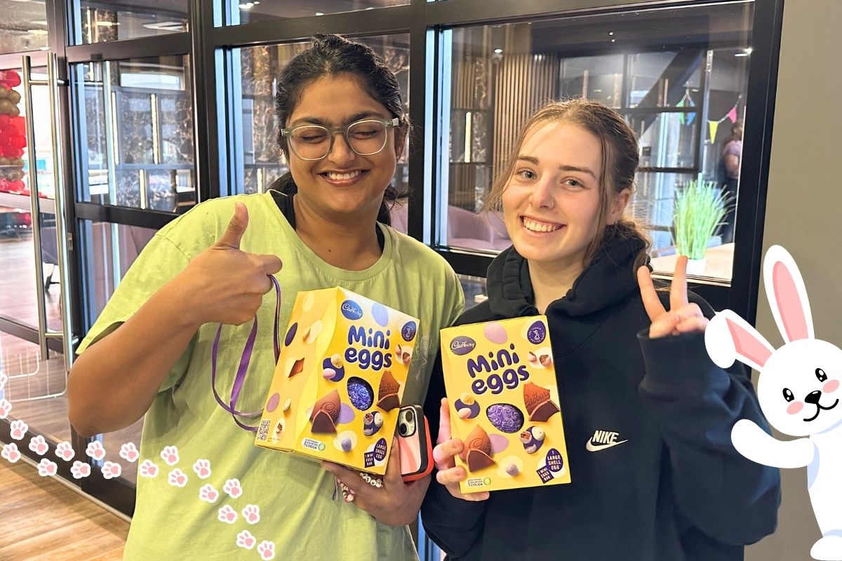 Two girls holding their eggs from the easter egg hunt