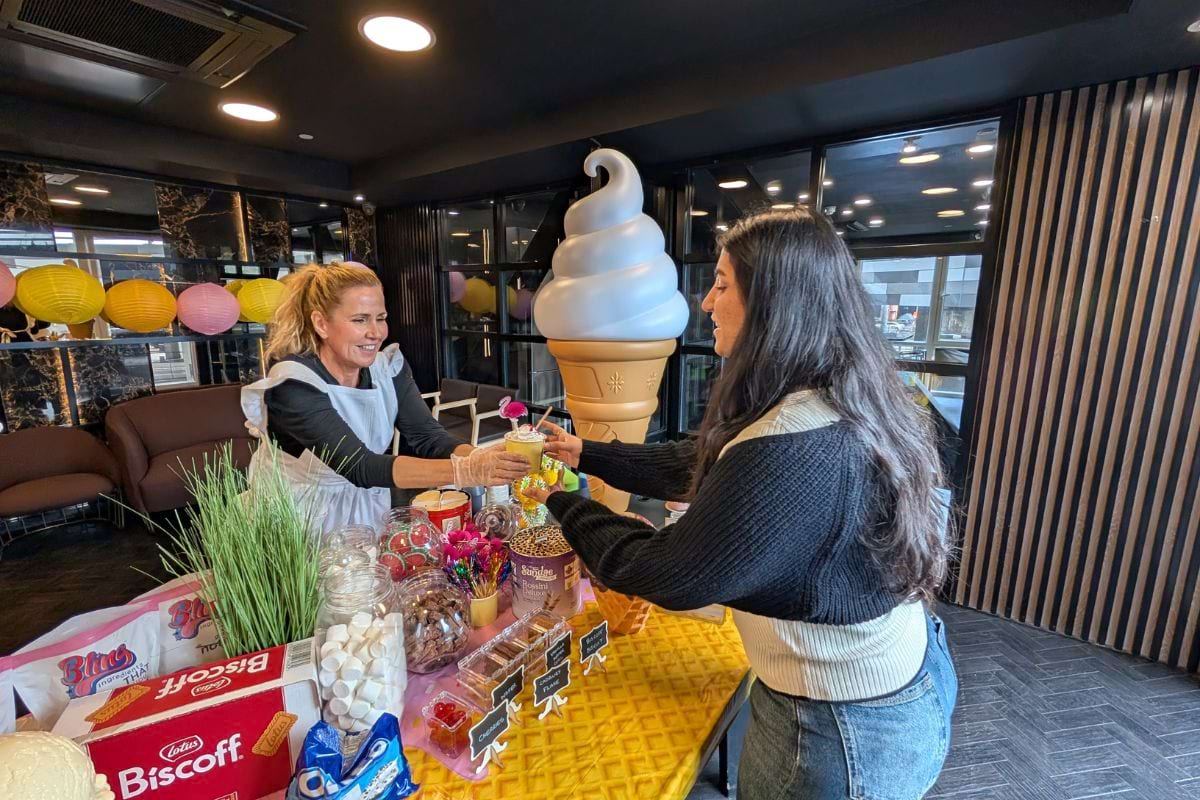 A CODE tenant being handed a cup och ice cream at the Ice cream parlour giveaway event at CODE Fairfax