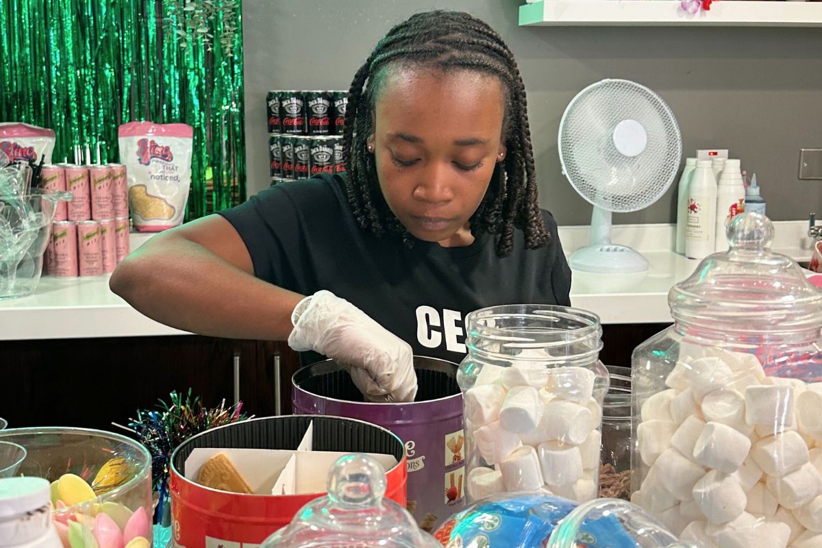A CODE team member serving ice creams