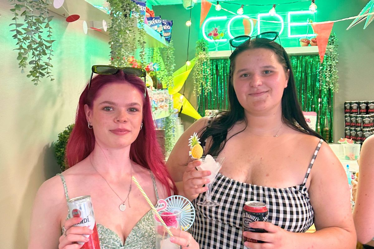 Two tenants standing in front of the bar with their drinks